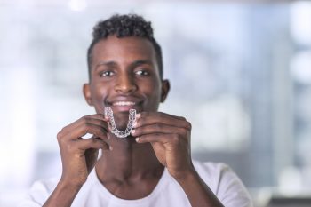 man with Invisalign aligners